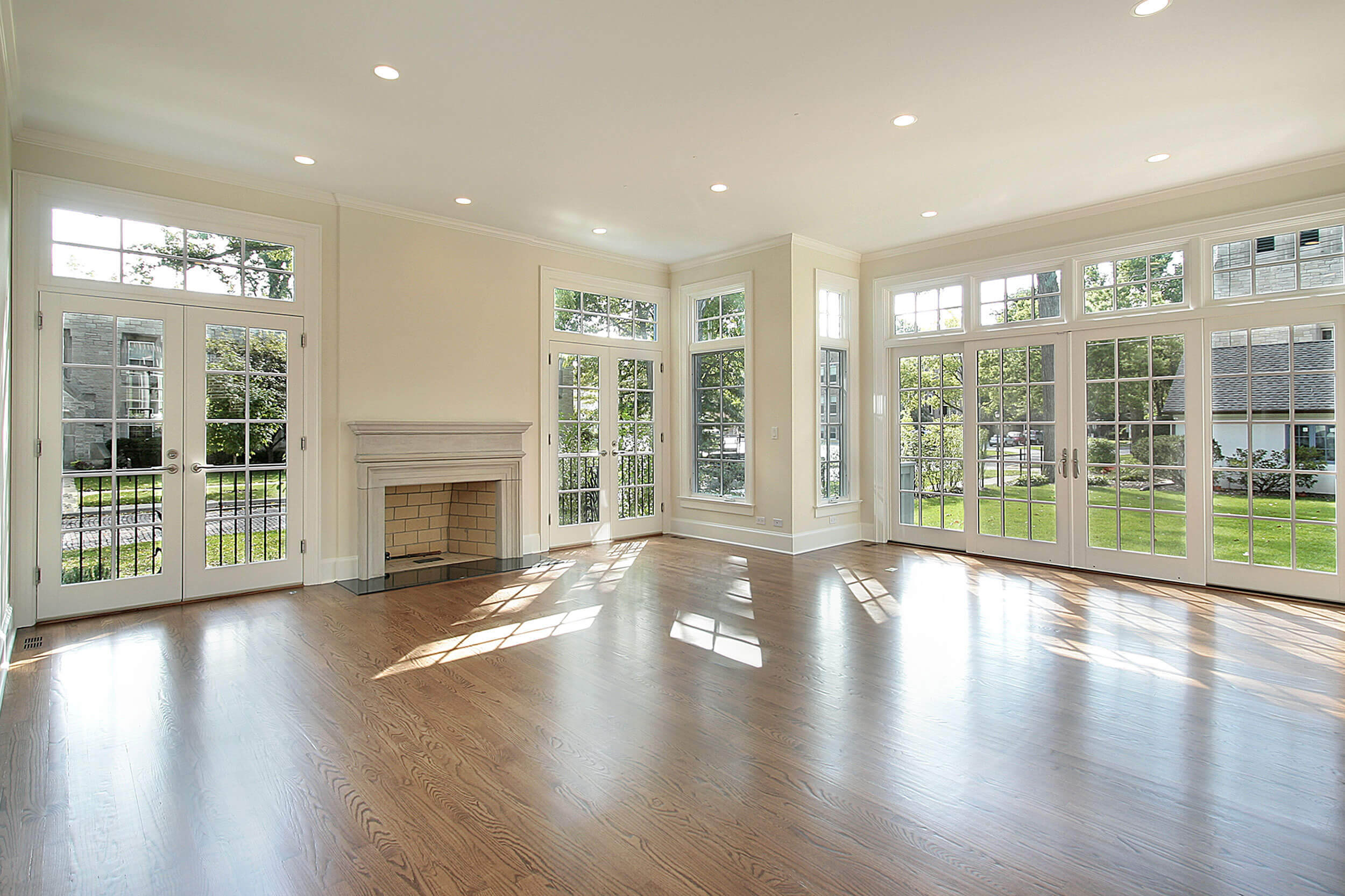 An open, well lit room with a fireplace.