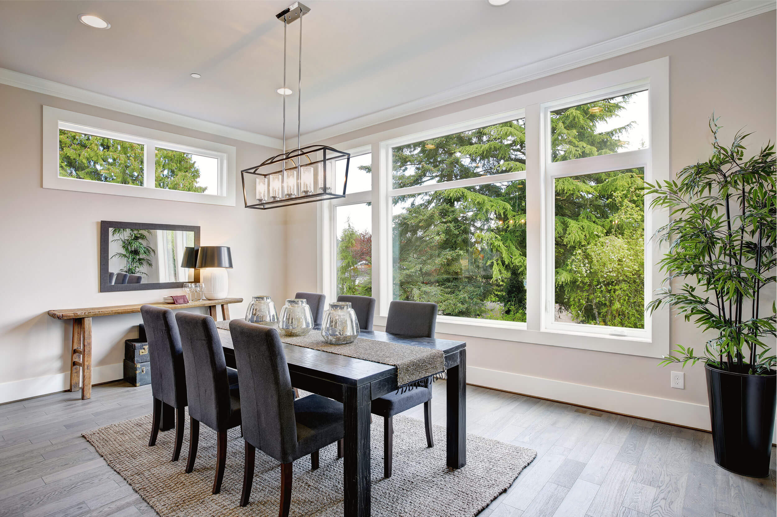 A dining table next to a large window